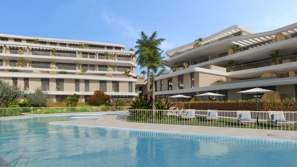 Resort-style hotel complex with a large outdoor pool, palm trees, and multi‑level balconies.