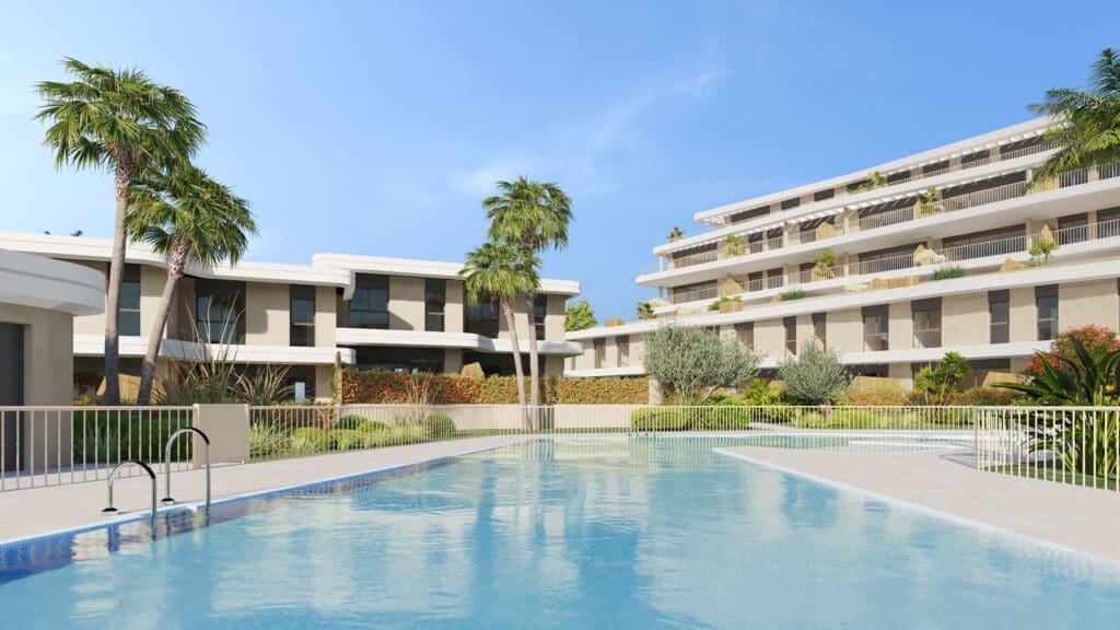 Outdoor resort pool surrounded by palm trees and modern white buildings on a sunny day, with clear blue water.
