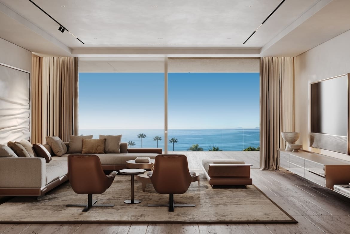Modern living room with a floor-to-ceiling window showing a blue ocean view; beige sofa, brown chairs, coffee table, and built-in shelves on the left.